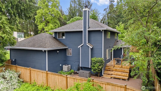 8221 122nd Ave NE, Kirkland, WA 98033 - back of house with a chimney, roof with shingles, central AC, and a deck