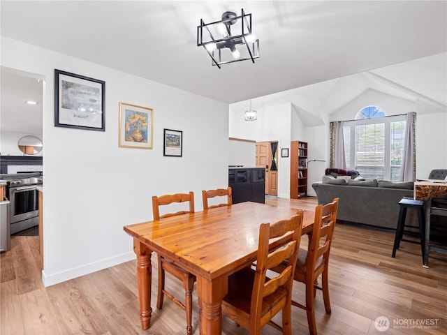 8221 122nd Ave NE, Kirkland, WA 98033 - dining area featuring light wood-type flooring, a chandelier, baseboards, and lofted ceiling