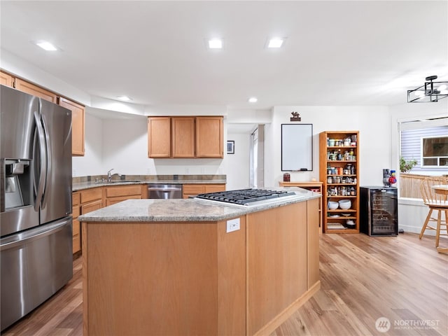 8221 122nd Ave NE, Kirkland, WA 98033 - kitchen featuring stainless steel appliances, wine cooler, a kitchen island, light wood finished floors, and light stone countertops