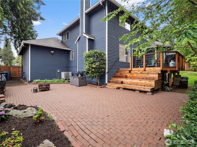 8221 122nd Ave NE, Kirkland, WA 98033 - back of house with an outdoor fire pit, a deck, a patio, central air condition unit, and a chimney