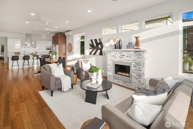 2222 Broadway E, Seattle, WA 98102 - living area featuring ceiling fan, wood finished floors, recessed lighting, a fireplace, and a wall mounted AC
