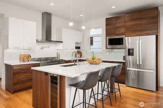 2222 Broadway E, Seattle, WA 98102 - kitchen with stainless steel appliances, wall chimney exhaust hood, beverage cooler, a sink, and modern cabinets