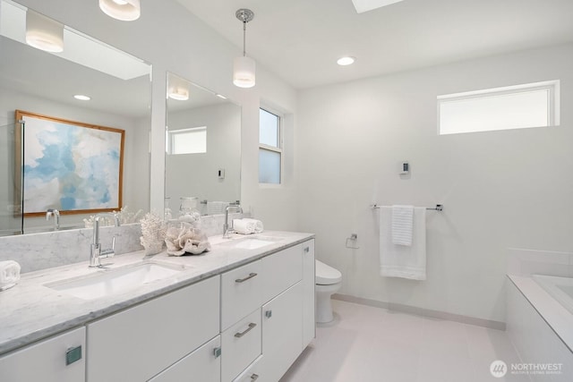 2222 Broadway E, Seattle, WA 98102 - bathroom featuring double vanity, toilet, a bath, and baseboards