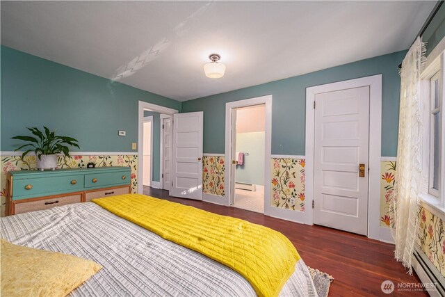 9316 7th Ave S, Seattle, WA 98108 - bedroom featuring baseboard heating, a wainscoted wall, wood finished floors, a baseboard radiator, and ensuite bathroom