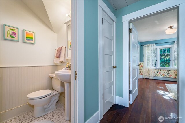 9316 7th Ave S, Seattle, WA 98108 - half bathroom featuring toilet, baseboard heating, wainscoting, hardwood / wood-style floors, and lofted ceiling