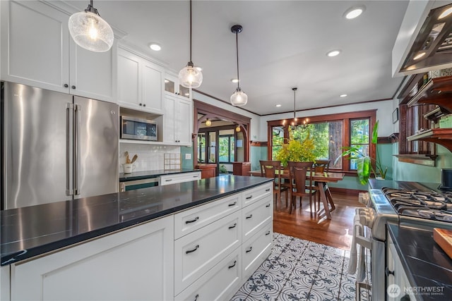 9316 7th Ave S, Seattle, WA 98108 - kitchen featuring appliances with stainless steel finishes, dark countertops, white cabinetry, recessed lighting, and tasteful backsplash