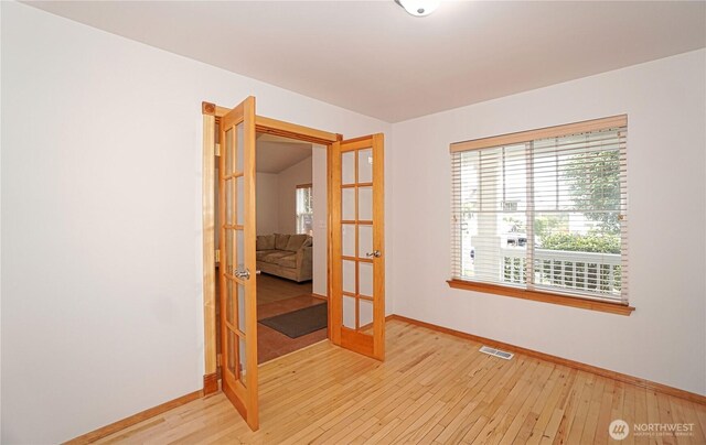 2820 V Ct SE, Auburn, WA 98002 - spare room featuring french doors, baseboards, healthy amount of natural light, and light wood finished floors