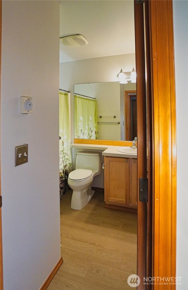 2820 V Ct SE, Auburn, WA 98002 - bathroom with wood finished floors, toilet, vanity, and curtained shower