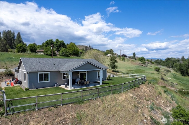 3 Kingfisher Rd, Twisp, WA 98856 - back of house featuring a patio, a view of countryside, and roof with shingles