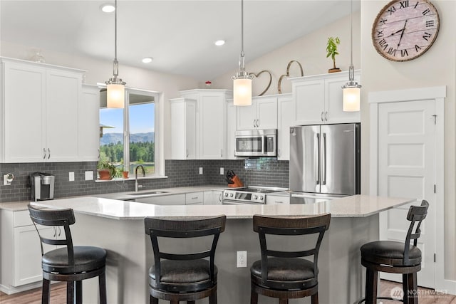 3 Kingfisher Rd, Twisp, WA 98856 - kitchen with stainless steel appliances, a sink, decorative backsplash, white cabinets, and decorative light fixtures