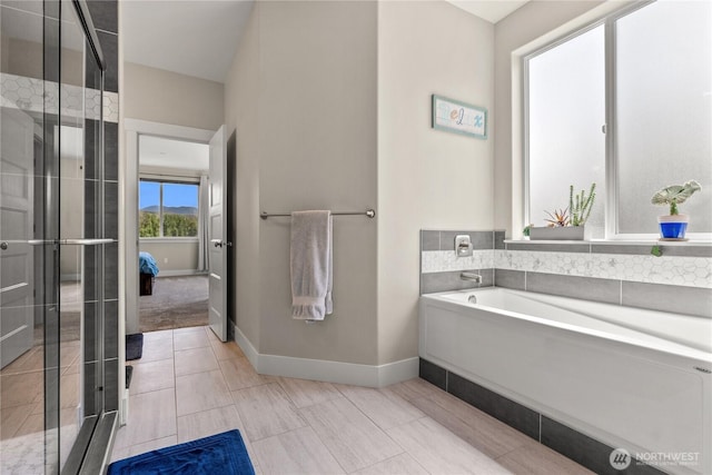 3 Kingfisher Rd, Twisp, WA 98856 - full bathroom featuring a garden tub, baseboards, a shower stall, and tile patterned flooring