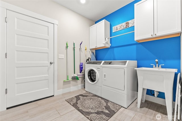 3 Kingfisher Rd, Twisp, WA 98856 - laundry room featuring washer and dryer, cabinet space, baseboards, and light wood finished floors