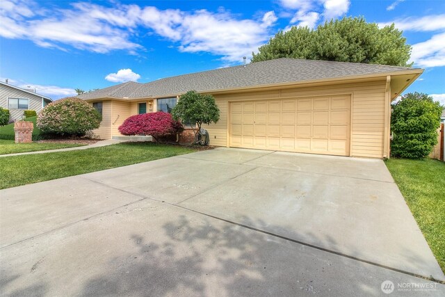 703 Tanarae Pl, Yakima, WA 98908 - ranch-style house featuring an attached garage, concrete driveway, and a front lawn