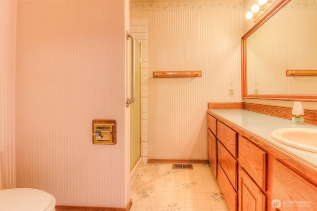 703 Tanarae Pl, Yakima, WA 98908 - bathroom featuring vanity, a shower stall, and wallpapered walls