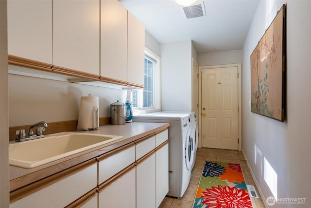9042 Gleneagle Dr, Blaine, WA 98230 - laundry room with cabinet space, washing machine and clothes dryer, and light tile patterned floors
