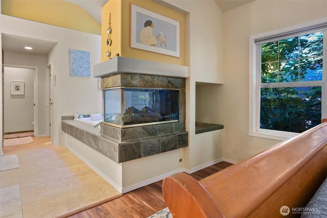 9042 Gleneagle Dr, Blaine, WA 98230 - living room with a multi sided fireplace and wood finished floors