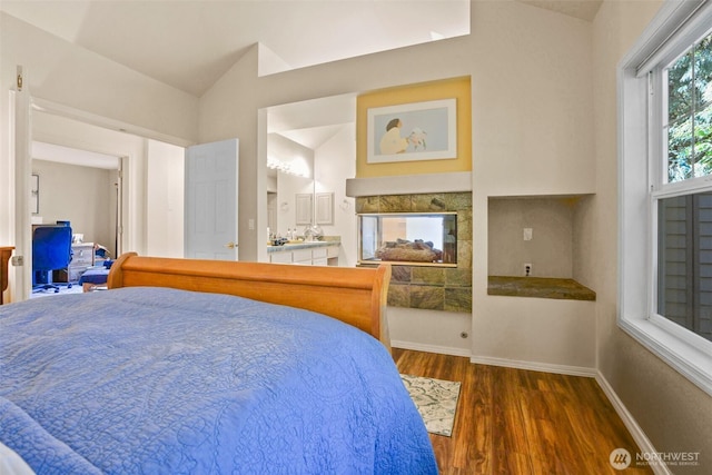 9042 Gleneagle Dr, Blaine, WA 98230 - bedroom with lofted ceiling, wood finished floors, and a multi sided fireplace