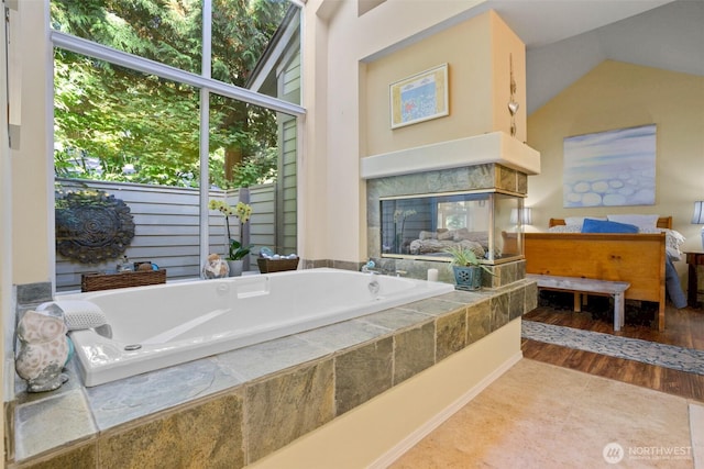 9042 Gleneagle Dr, Blaine, WA 98230 - full bath featuring a bath, healthy amount of natural light, wood finished floors, and vaulted ceiling