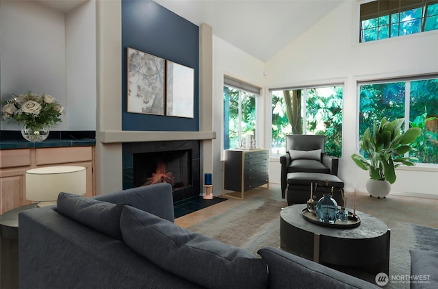 9042 Gleneagle Dr, Blaine, WA 98230 - living area featuring a tiled fireplace, high vaulted ceiling, and concrete floors