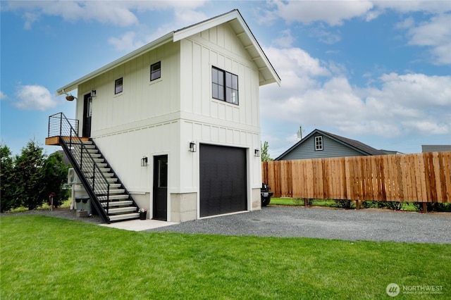 515 Mitchell St, Sumas, WA 98295 - view of front facade with board and batten siding, stairs, driveway, and a garage