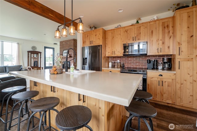 515 Mitchell St, Sumas, WA 98295 - kitchen featuring stainless steel appliances, backsplash, light brown cabinets, dark wood-type flooring, and beamed ceiling