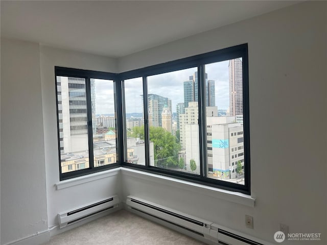 1105 Spring Unit 1309, Seattle, WA 98104 - unfurnished room featuring healthy amount of natural light, carpet flooring, a view of city, and a baseboard heating unit