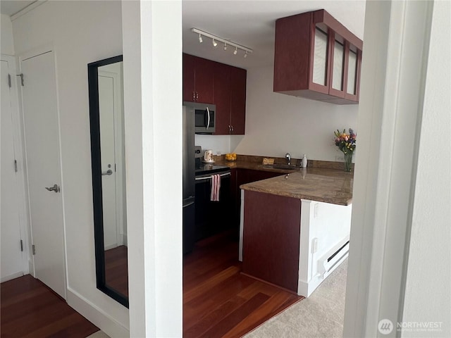 1105 Spring Unit 1309, Seattle, WA 98104 - kitchen featuring range with electric stovetop, stainless steel microwave, dark wood-style flooring, and a peninsula