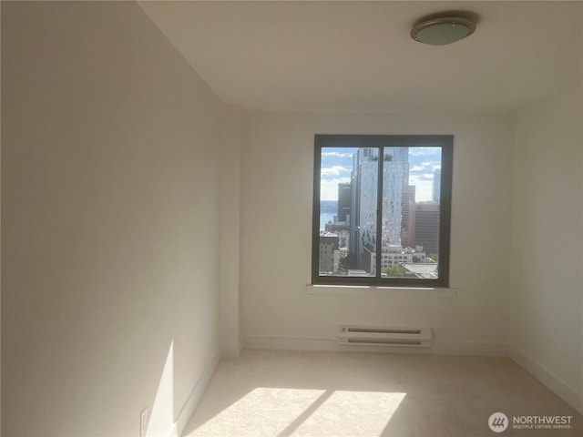 1105 Spring Unit 1309, Seattle, WA 98104 - carpeted empty room with a baseboard radiator and baseboards