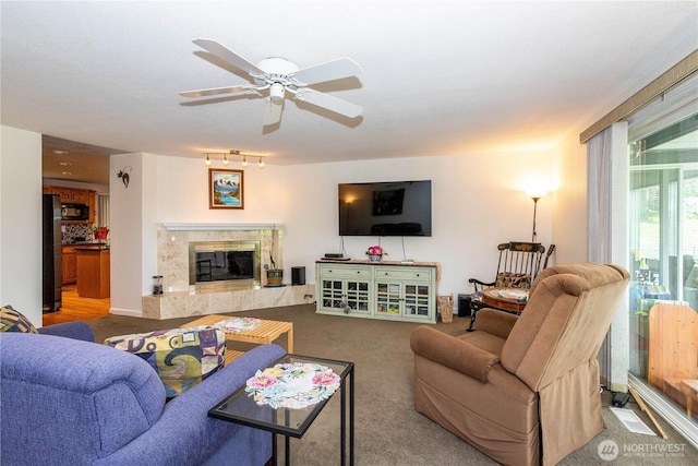 4025 Somerset Ln, Kent, WA 98032 - living room with a high end fireplace, ceiling fan, and carpet