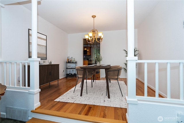 4025 Somerset Ln, Kent, WA 98032 - home office featuring wood finished floors, a chandelier, ornate columns, and baseboards