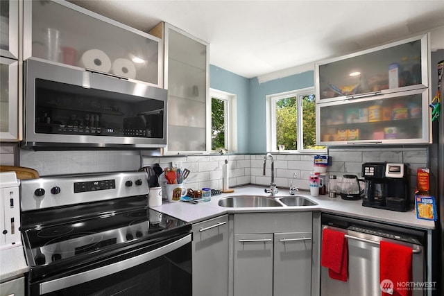 7431 S 132nd St, Seattle, WA 98178 - kitchen with stainless steel appliances, a sink, light countertops, and decorative backsplash
