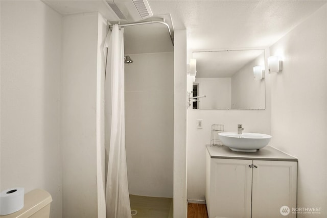 7431 S 132nd St, Seattle, WA 98178 - full bathroom featuring a shower with shower curtain, vanity, toilet, and wood finished floors