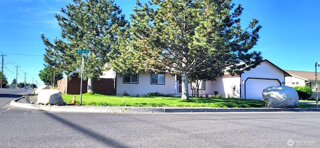390 4th Ave SE, Ephrata, WA 98823 - obstructed view of property featuring an attached garage and a front yard