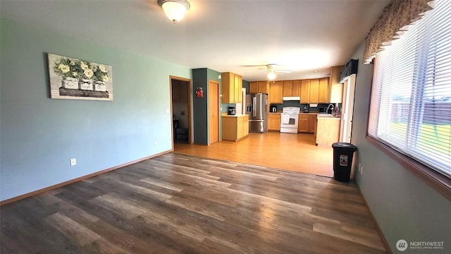 390 4th Ave SE, Ephrata, WA 98823 - kitchen featuring stainless steel fridge with ice dispenser, white range with electric cooktop, light countertops, wood finished floors, and under cabinet range hood