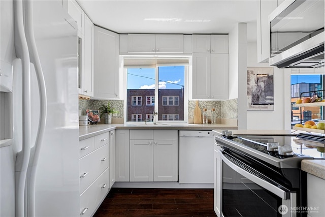 613 4th Ave W Unit 202, Seattle, WA 98119 - kitchen featuring white appliances, dark wood-style flooring, light countertops, and white cabinetry