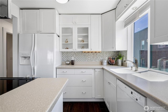 613 4th Ave W Unit 202, Seattle, WA 98119 - kitchen with white appliances, a sink, and white cabinetry