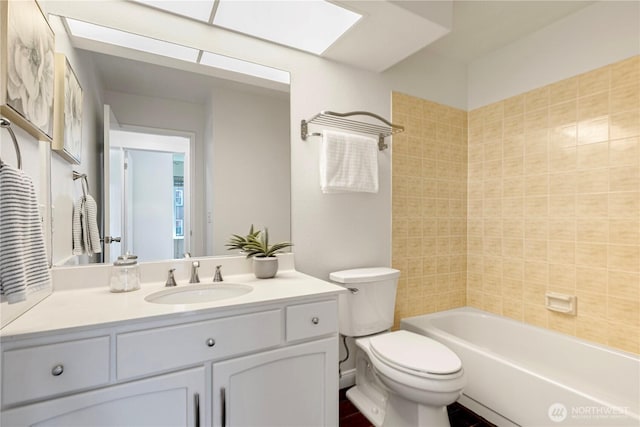 613 4th Ave W Unit 202, Seattle, WA 98119 - full bathroom featuring vanity, toilet,  shower combination, and a skylight