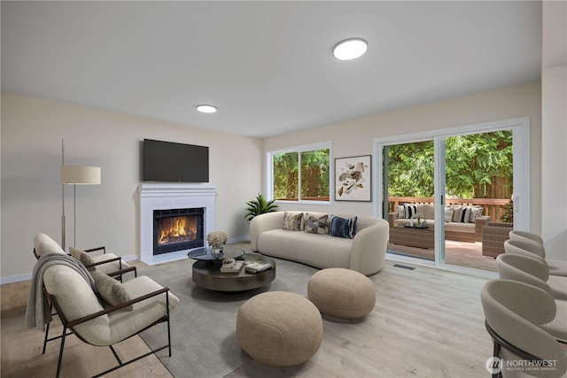 2021 224th Pl NE, Sammamish, WA 98074 - living room featuring a brick fireplace, light wood-style flooring, and baseboards