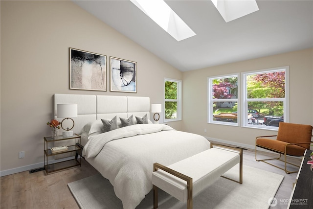 2021 224th Pl NE, Sammamish, WA 98074 - bedroom featuring a skylight, vaulted ceiling, baseboards, and light wood finished floors