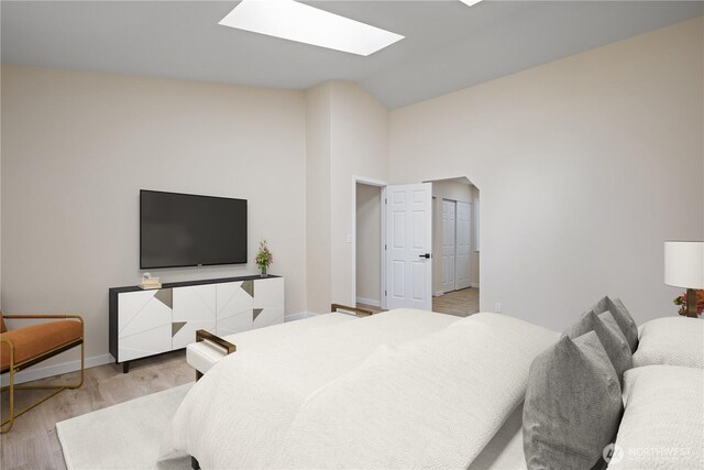 2021 224th Pl NE, Sammamish, WA 98074 - bedroom with vaulted ceiling, a skylight, light wood finished floors, and baseboards