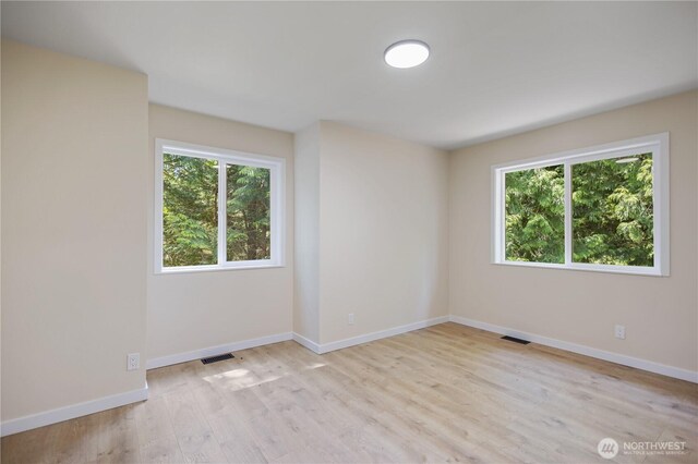 2021 224th Pl NE, Sammamish, WA 98074 - empty room with plenty of natural light, light wood-style flooring, and baseboards