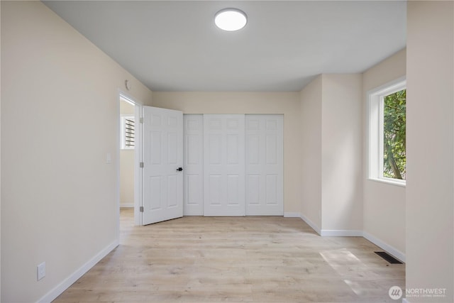 2021 224th Pl NE, Sammamish, WA 98074 - unfurnished bedroom featuring baseboards, light wood-style flooring, and a closet