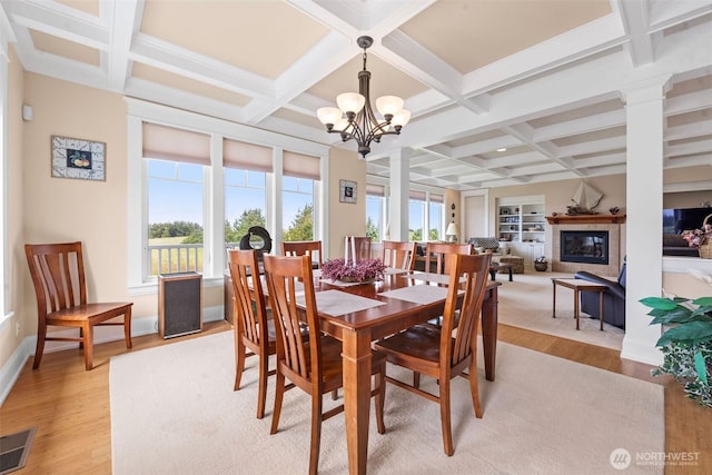 234 26th St NW, Long Beach, WA 98631 - dining area with light wood finished floors, coffered ceiling, a chandelier, beam ceiling, and a glass covered fireplace