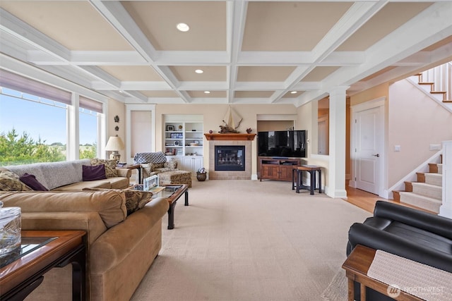 234 26th St NW, Long Beach, WA 98631 - living room featuring stairway, coffered ceiling, a tiled fireplace, beamed ceiling, and ornate columns