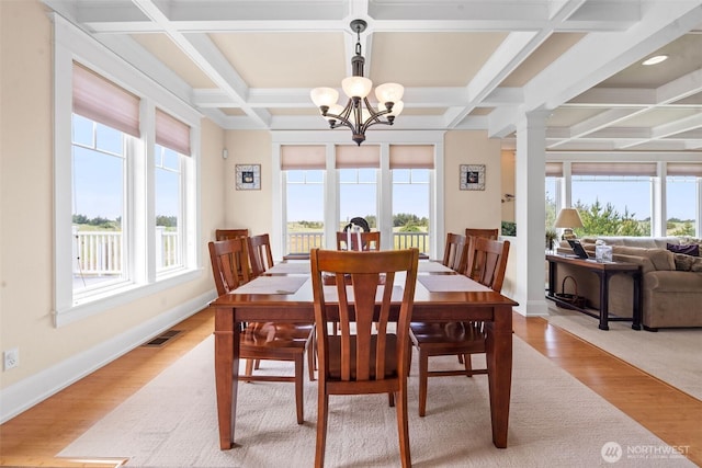 234 26th St NW, Long Beach, WA 98631 - dining area with plenty of natural light, a chandelier, coffered ceiling, light wood-style flooring, and beam ceiling