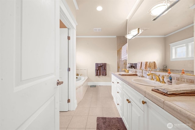 234 26th St NW, Long Beach, WA 98631 - full bathroom with double vanity, tile patterned flooring, a garden tub, crown molding, and baseboards