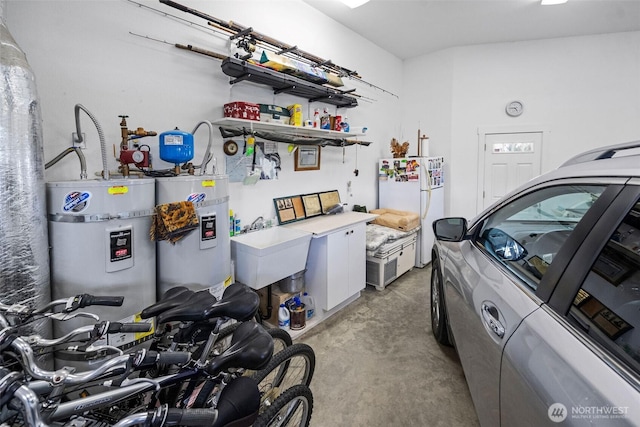 234 26th St NW, Long Beach, WA 98631 - garage with electric water heater, freestanding refrigerator, and a sink
