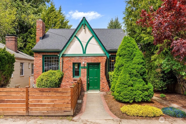 1214 NE 98th St, Seattle, WA 98115 - tudor home featuring brick siding, roof with shingles, and a chimney