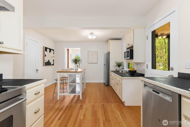 1214 NE 98th St, Seattle, WA 98115 - kitchen with appliances with stainless steel finishes, light wood-style flooring, and healthy amount of natural light