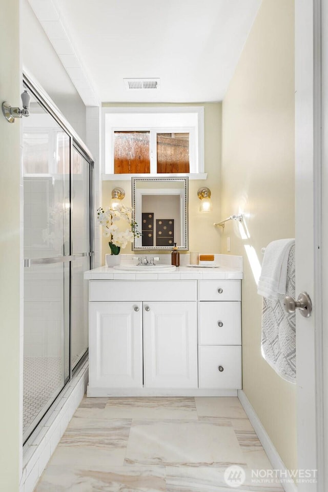 1214 NE 98th St, Seattle, WA 98115 - full bathroom featuring vanity, a shower stall, baseboards, and marble finish floors